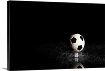 Soccer ball on black reflective surface