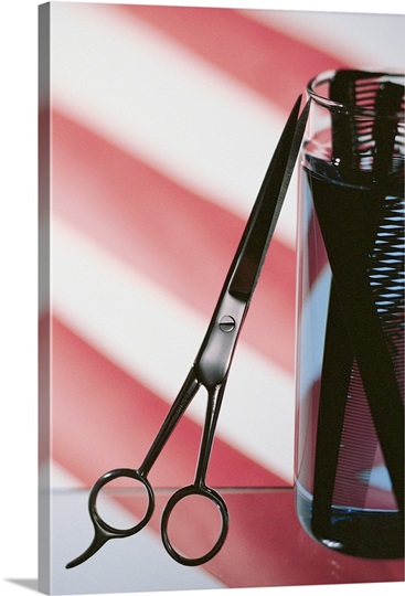 Still life of barbershop pole with scissors and combs
