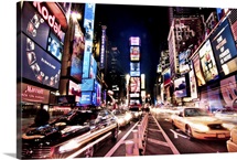 The heart of Times Square Manhattan, at night, with glowing neon signs and ads