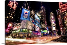 Times Square at night with glowing neon, car light trails.
