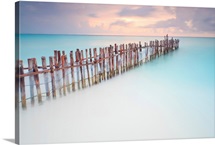 Tranquil scene of Wooden posts in Caribbean sea, at sunset right after storm.