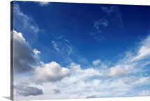 White fluffy clouds on blue sky.