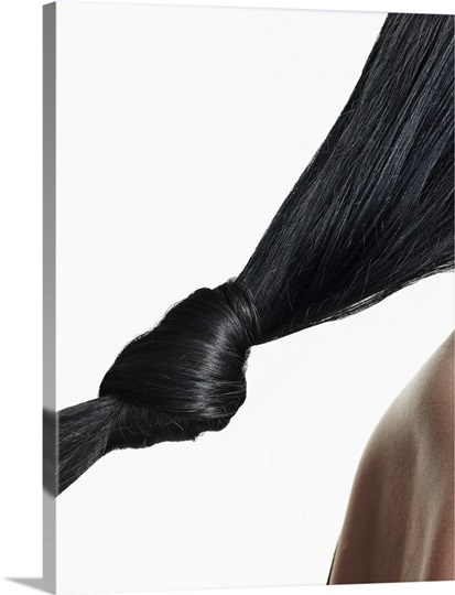 Woman with hair tied in knot, close-up of hair