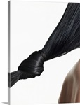 Woman with hair tied in knot, close-up of hair