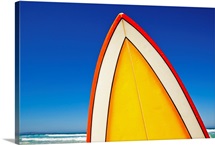 Yellow and orange retro surfboard at beach, Eyre Peninsula, South Australia.