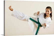 Young girl doing karate kick