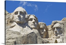 Ropes hang over Mount Rushmore's faces as people get ready to repel down
