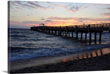 The sun rises over an Atlantic Ocean pier
