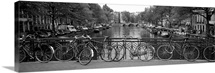 Bicycle leaning against a metal railing on a bridge, Amsterdam, Netherlands