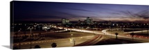 Buildings in a city lit up at dusk, 7th St. Freeway, Phoenix, Maricopa County, Arizona