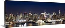 Buildings in a city lit up at dusk, Hudson River, Midtown Manhattan, Manhattan, New York City, New York State,