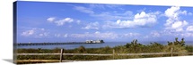 Fence on the beach with a pier in the background, Anna Maria Island City Pier, Tampa Bay, Gulf of Mexico, Anna Maria Island, Florida