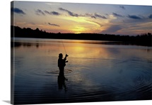 Fly-fisherman silhouetted by sunrise, Mauthe Lake, Kettle Moraine State Forest, Wisconsin