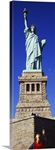 Low angle view of a tourist taking a picture of a statue, Statue of Liberty, Liberty State Park, Liberty Island, New York City, New York State