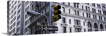 Low angle view of a traffic light in front of a building, Wall Street, New York City, New York State
