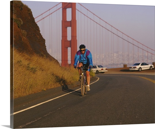 Mid adult man cycling, Golden Gate Bridge, San Francisco, California