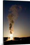 Old Faithful Geyser Erupting At Sunset