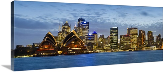Opera house and buildings lit up at dusk Sydney Opera House Sydney Harbor Sydney New South Wales Australia