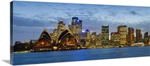 Opera house and buildings lit up at dusk Sydney Opera House Sydney Harbor Sydney New South Wales Australia