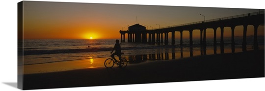 Silhouette of a person cycling on the beach, Manhattan, New York City, New York State