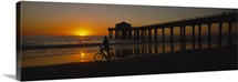 Silhouette of a person cycling on the beach, Manhattan, New York City, New York State