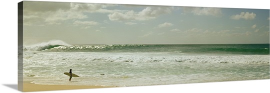 Surfer standing on the beach, North Shore, Oahu, Hawaii,