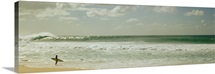 Surfer standing on the beach, North Shore, Oahu, Hawaii,