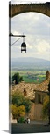 Umbrian countryside viewed through an alleyway, Assisi, Perugia Province, Umbria, Italy