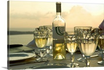 Wine glasses with a wine bottle on a table, Santorini, Cyclades Islands, Greece