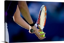 Detail of woman serving during tennis match