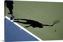 Shadow of tennis player serving