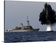 A demolition charge detonates 1,500 meters in front of USS Scout