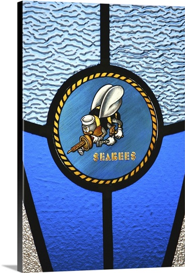 A single Seabee logo built into a stainedglass window