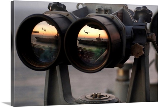 Aircraft carrier USS Dwight D Eisenhower is reflected in a set of Big Eyes binoculars