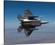 An F-22 Raptor maneuvers while flying a training mission over New Mexico