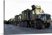 Armored trucks sit on the pier at Morehead City North Carolina awaiting deployment