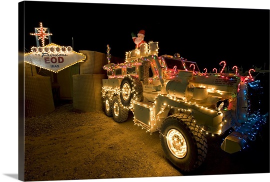 Cougar MRAP is adorned in holiday lights parked in front of EOD Iraq