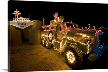 Cougar MRAP is adorned in holiday lights parked in front of EOD Iraq