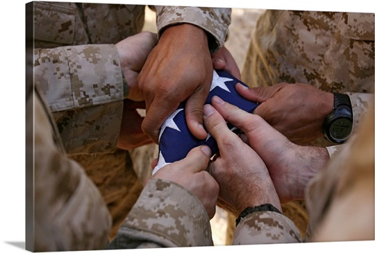 Marines fold an American flag