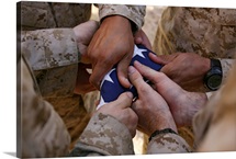 Marines fold an American flag