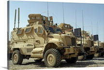 Mine Resistant Ambush Protected vehicles sit in parking area at Joint Base Balad Iraq
