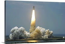 Space Shuttle Atlantis lifts off into the sky