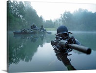 Special operations forces combat diver transits the water armed with an assault rifle