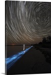 Star trails over bioluminescence in waves on the shores of the Gippsland Lakes Australia