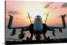 The sun rises on an F/A18 Hornet