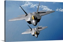 Two F22 Raptors fly over the Pacific Ocean