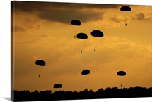 U.S. Army Soldiers parachute through the sky