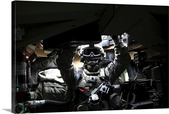 US Army Specialist adjusts his gunners safety harness prior to a patrol in Afghanistan