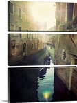 Two gondolas floating in water surrounded by old buildings.