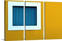 Window on yellow wall.